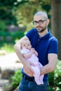 Cute little baby girl in her father`s arms Royalty Free Stock Photo