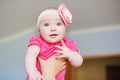 Portrait of cute little baby girl with pink bow flower on her head Royalty Free Stock Photo