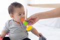 Portrait of cute little baby girl sitting with cozy on bed at bedroom, happiness of toddler. Royalty Free Stock Photo