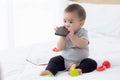 Portrait of cute little baby girl sitting with cozy on bed at bedroom, happiness of toddler. Royalty Free Stock Photo