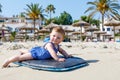 Portrait of cute little baby girl in swim suit on beach in summer. Royalty Free Stock Photo