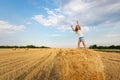 Portrait of cute little blond beautiful adorable cheerful caucasian kid girl enjoy sitting on hay stack or bale on Royalty Free Stock Photo