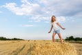 Portrait of cute little blond beautiful adorable cheerful caucasian kid girl enjoy sitting on hay stack or bale on Royalty Free Stock Photo