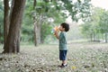 Portrait of Cute little boy blowing bubbles with gun that blows soap bubbles in the park at the day time. Kid plays with soap Royalty Free Stock Photo