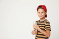 Portrait of cute little boy with books on grey background. Reading concept Royalty Free Stock Photo