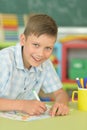 Portrait of cute little boy drawing in classroom Royalty Free Stock Photo