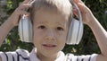 Portrait of Cute Little Boy With Headphones Listening to Music. Cheerful Carefree Childhood. Preschool Girl Feeling Free Royalty Free Stock Photo