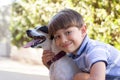 Portrait of cute little boy hugging dog Royalty Free Stock Photo