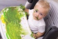 Portrait of a cute little boy messily playing with paints Royalty Free Stock Photo