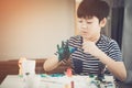 Portrait of a cute little boy messily playing with paints. Royalty Free Stock Photo