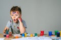 Portrait of a cute little boy messily playing with paints Royalty Free Stock Photo