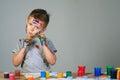 Portrait of a cute little boy messily playing with paints Royalty Free Stock Photo