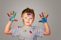 Portrait of a cute little boy messily playing with paints Royalty Free Stock Photo