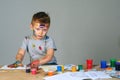 Portrait of a cute little boy messily playing with paints Royalty Free Stock Photo