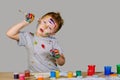 Portrait of a cute little boy messily playing with paints Royalty Free Stock Photo