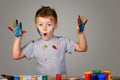 Portrait of a cute little boy messily playing with paints Royalty Free Stock Photo