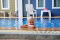 Portrait boy child in swimming pool home summer holiday, outdoors Royalty Free Stock Photo