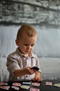 Little boy playing with letters and numbers on a table Royalty Free Stock Photo