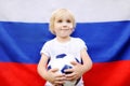 Portrait of cute little boy with russian flag on background