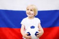 Portrait of cute little boy with russian flag on background