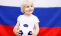 Portrait of cute little boy with russian flag on background