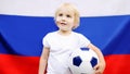 Portrait of cute little boy with russian flag on background