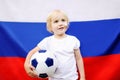 Portrait of cute little boy with russian flag on background