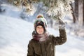 Portrait of a cute little boy in warm clothes playing outdoors during snowfall in winter sunny day Royalty Free Stock Photo