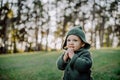 Portrait of cute little boy wearing knitted hoodie in nautre, autumn concept. Royalty Free Stock Photo