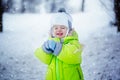 Portrait of cute little boy in winter clothes with falling snow. Kid playing and smiling in nature cold day Royalty Free Stock Photo