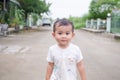 Portrait cute little boy about 2 year olds standing on road. he happy smile.