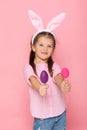 Cute little girl with Easter bunny ears holding colorful eggs Royalty Free Stock Photo