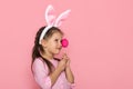 Cute little girl with Easter bunny ears holding colorful eggs Royalty Free Stock Photo