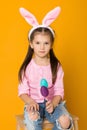 Cute little girl with Easter bunny ears holding colorful eggs Royalty Free Stock Photo