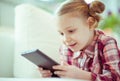 Portrait of cute little child girl with tablet at digital homeschooling Royalty Free Stock Photo