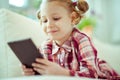 Portrait of cute little child girl with tablet at digital homeschooling Royalty Free Stock Photo