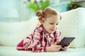 Portrait of cute little child girl with tablet at digital homeschooling Royalty Free Stock Photo