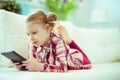Portrait of cute little child girl with tablet at digital homeschooling Royalty Free Stock Photo