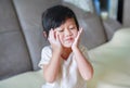 Portrait of cute little girl with baby powder on her face. Little girl pour the talcum to the hand