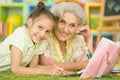 Portrait of a cute little girl drawing with her grandmother Royalty Free Stock Photo