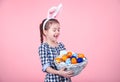 Portrait of a cute little girl with an Easter egg basket on an isolated pink background Royalty Free Stock Photo