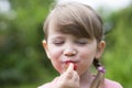 Portrait of a cute little girl eating strawberries Royalty Free Stock Photo