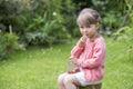 Portrait of a cute little girl eating strawberries, looking came Royalty Free Stock Photo