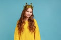 Portrait of cute little girl in golden diadem crown standing, looking at camera with toothy smile.