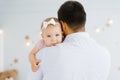 Portrait of cute little girl held in father`s arms. Happy loving family. Father and his daughter child girl. Cute baby and daddy. Royalty Free Stock Photo