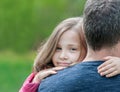 Portrait of cute little girl held in father`s arms. Happy loving family. Father and his daughter child girl playing hugging Royalty Free Stock Photo