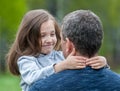 Portrait of cute little girl held in father`s arms. Happy loving family. Father and his daughter child girl playing hugging Royalty Free Stock Photo