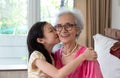 Portrait of cute little girl and her beautiful grandma sitting o Royalty Free Stock Photo