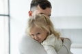 Portrait of a cute little girl in her father& x27;s arms. A father and his daughter, a baby girl, play cuddling. Royalty Free Stock Photo