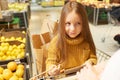 Little Girl Sitting in Shopping Cart Royalty Free Stock Photo